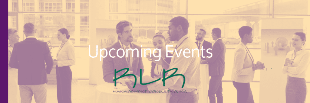 A group of people standing around talking to each other.